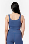 Back of a woman wearing square side of a reversible ribbed sports bra in blue