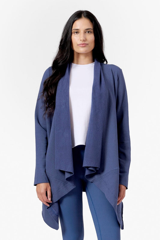 Woman wearing a blue drapey fleece jacket 