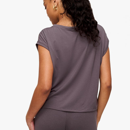 back of a woman wearing a sleeveless top in deep purple