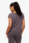 back of a woman wearing a sleeveless top in deep purple