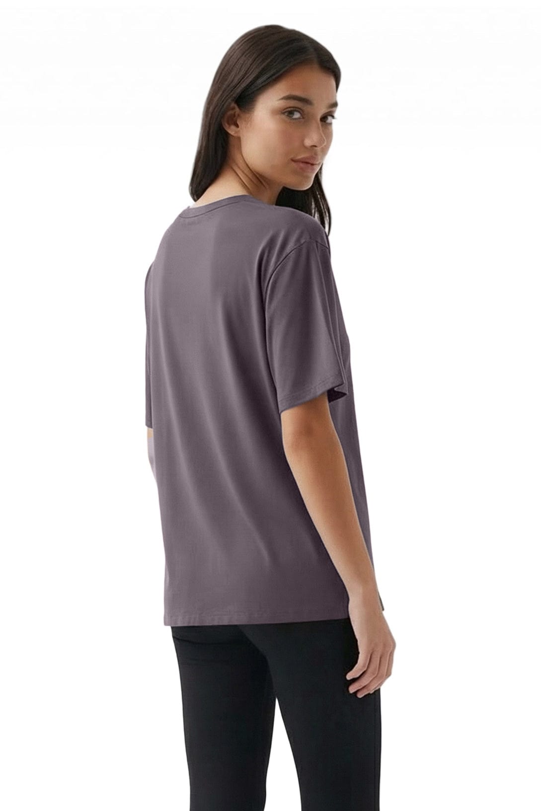 Woman wearing a gray t-shirt and black leggings on a white background