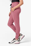 Side of a woman wearing cozy pink fleece joggers
