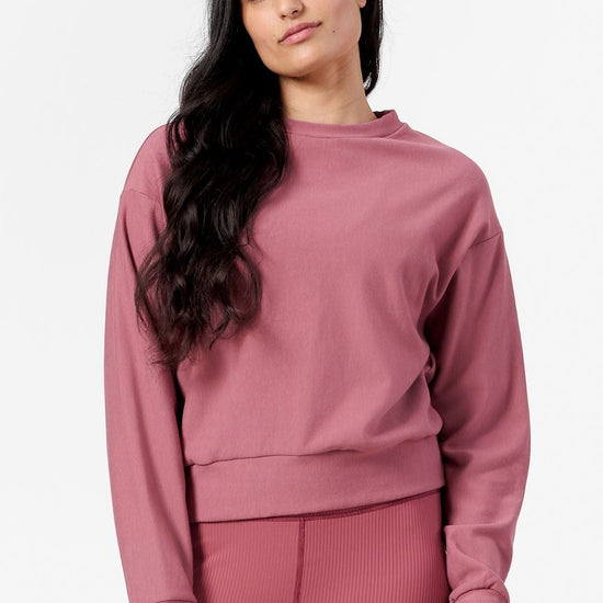 Woman wearing pink crew neck sweatshirt