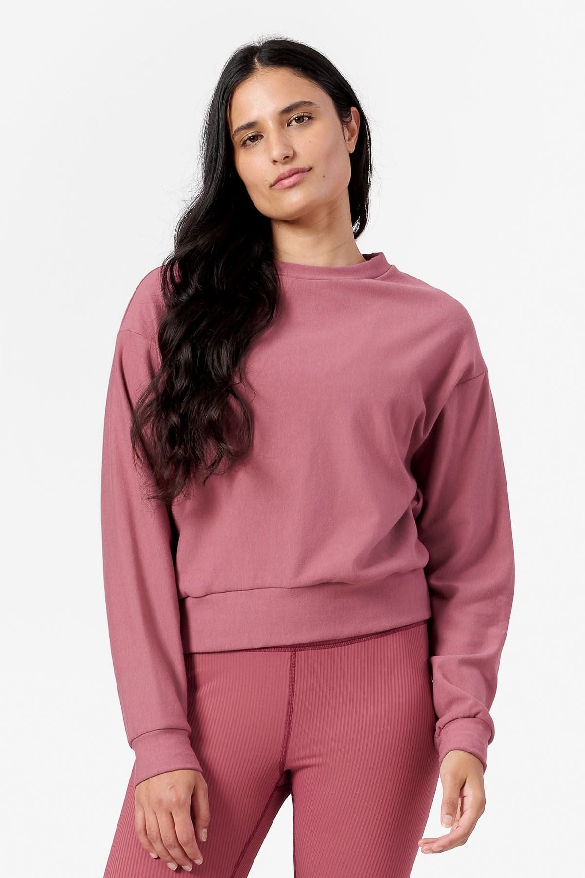 Woman wearing pink crew neck sweatshirt