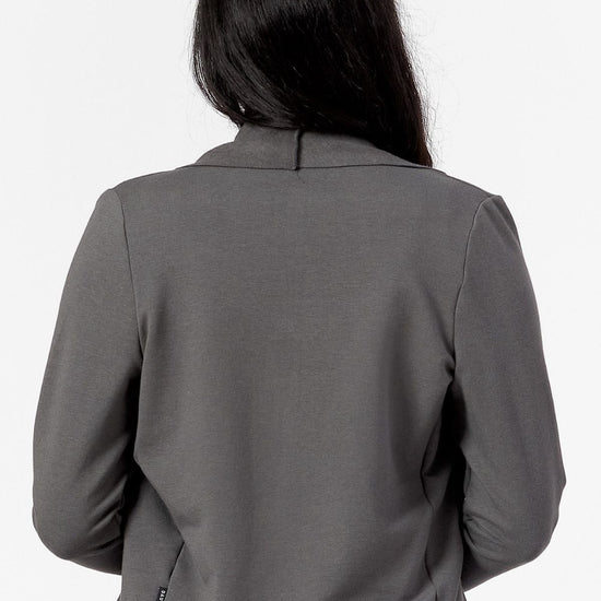 back view of a woman wearing a green jacket made form fleece