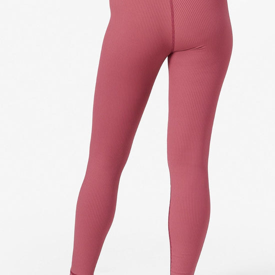 back view of a woman wearing ribbed pink leggings