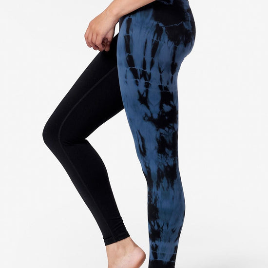 half view of the side of a woman's leggings with  blue and black tie dye