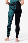 back view of a woman's legs wearing leggings which are tie dye teal and black