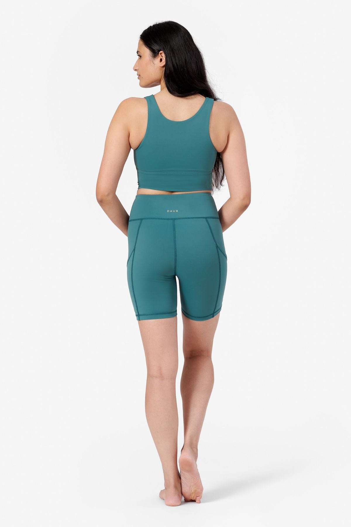 back view of bike shorts in teal with matching teal crop top