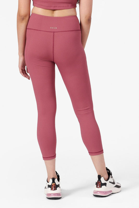 back view of a woman wearing ribbed leggings that are pink