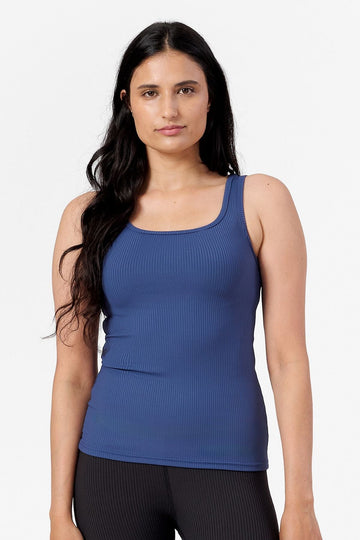 a woman wearing blue sports tank made from a ribbed fabric