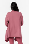 back view of a woman wearing a pink fleece jacket