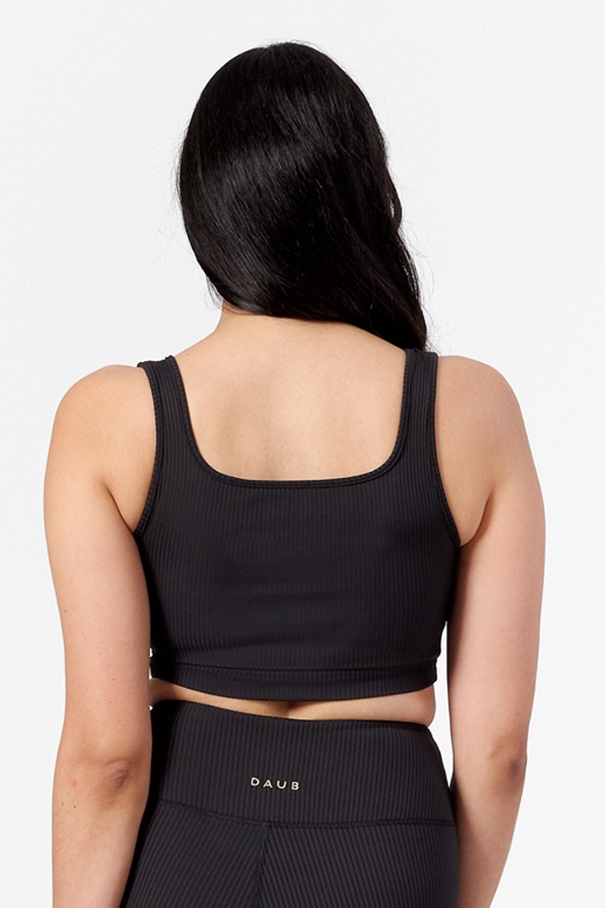 woman wearing black ribbed bra. back view. square neck line