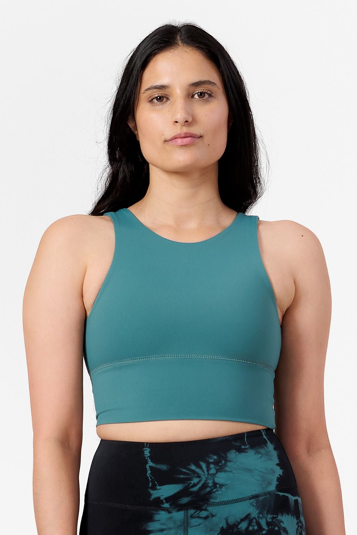 a woman wearing a reversible high neck sports bra
