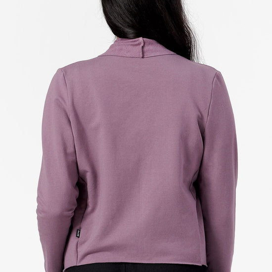 Back of a woman wearing a purple jacket