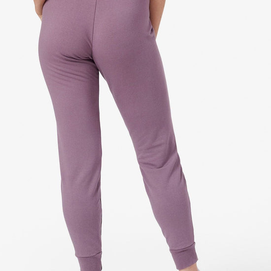 Back of a woman wearing purple joggers