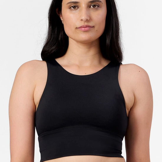 a woman wearing a reversible black bra with high neck