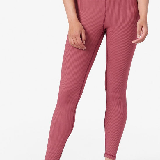 bottom view of a woman wearing ribbed pink full length leggings