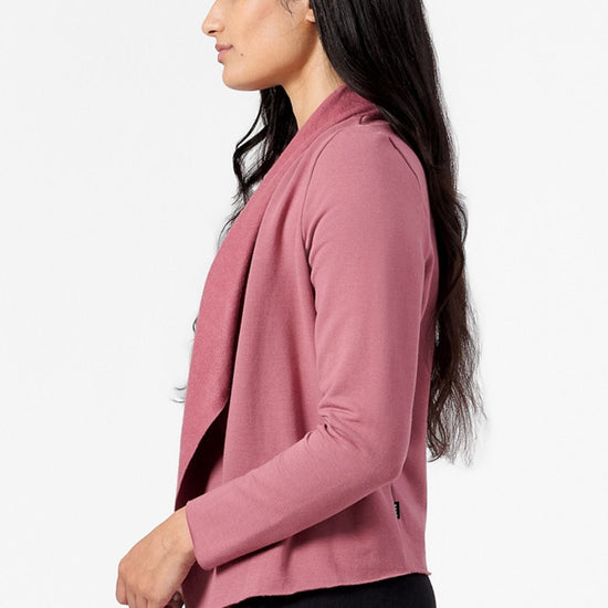 Side of a woman wearing a pink jacket