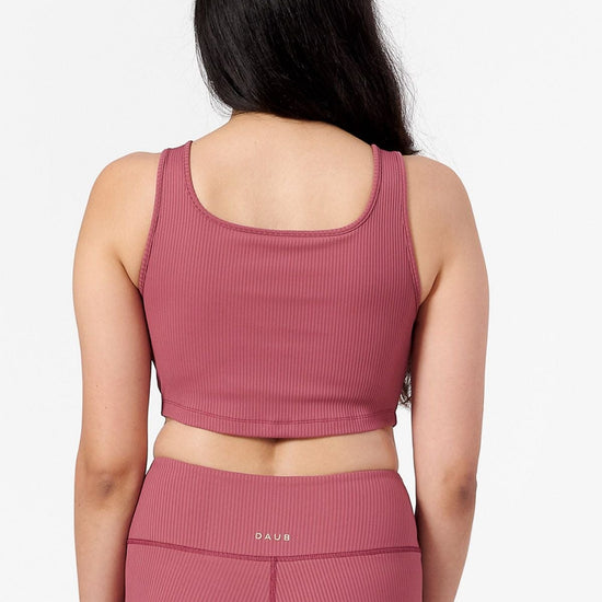 back of woman wearing a square neck ribbed cropped tank top in pink