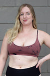 Blonde woman wearing a tie-dye swim top 