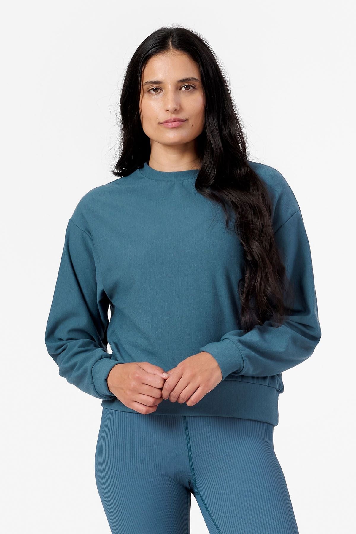 Woman wearing teal sweatshirt
