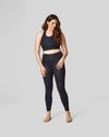 A size 12 model wears a size L in the black cheetah print long-line sports bra and high waisted legging.