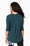 Back of a woman wearing a green 3/4 length tee that is longer at the back
