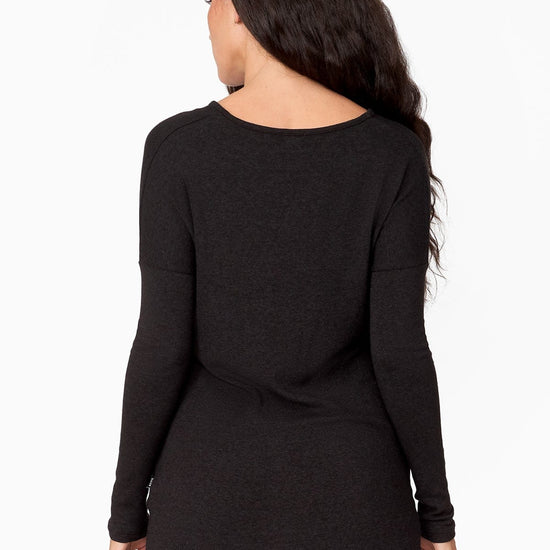 The back of a woman wearing a long longsleeve sweater.
