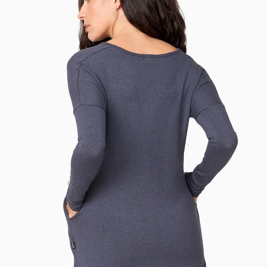 Back of a woman wearing a blue sweater.