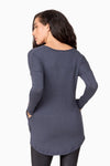 Back of a woman wearing a blue sweater.