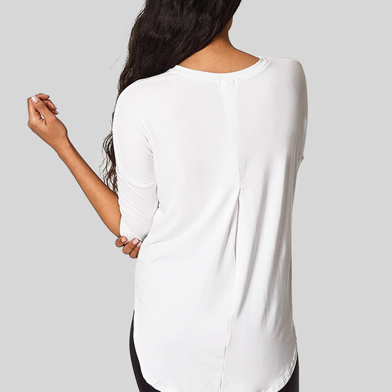 The back view of the Ainsley Tee with a back box pleat and low hem for bum coverage.