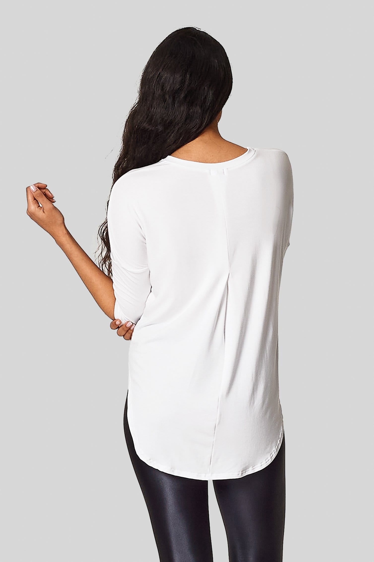 The back view of the Ainsley Tee with a back box pleat and low hem for bum coverage.