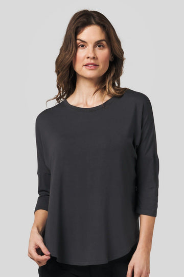 Woman wearing a dark grey 3/4 length sleeve shirt