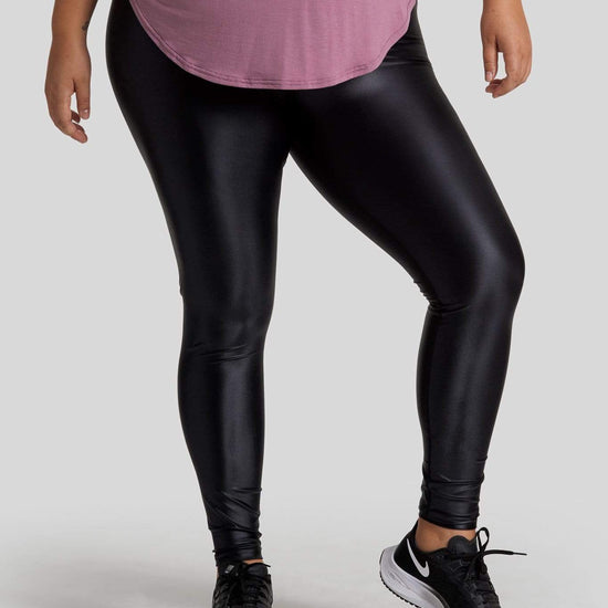 A woman's legs are shown wearing liquid black leggings