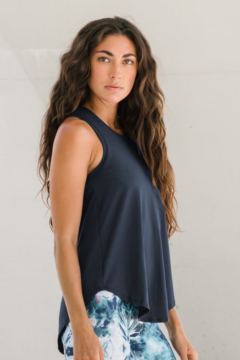 A woman wearing a dark blue gray tank top