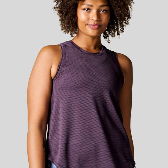 Woman wearing a Deep Purple Alex Tank paired with Bike Shorts in Periwinkle