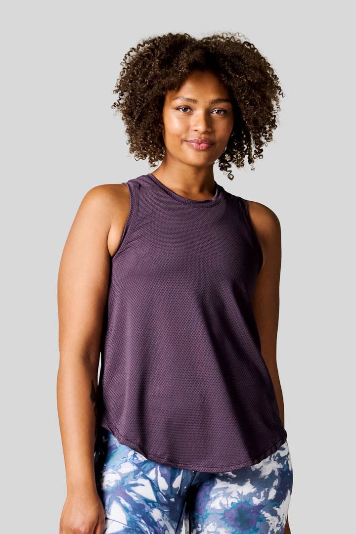 Woman wearing a Deep Purple Alex Tank paired with Bike Shorts in Periwinkle