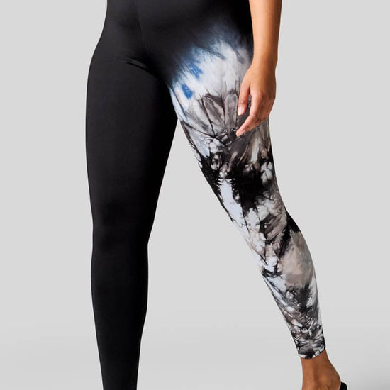 Woman wearing tie-dye leggings and Freedom Moses.