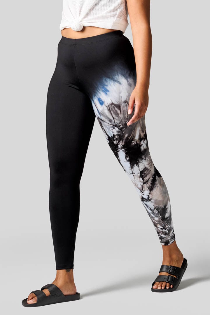 Woman wearing tie-dye leggings and Freedom Moses.
