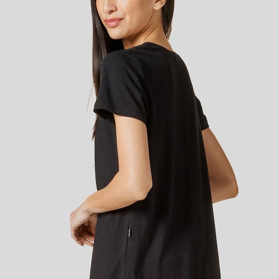 Women looking at her back wearing a black short sleeve shirt
