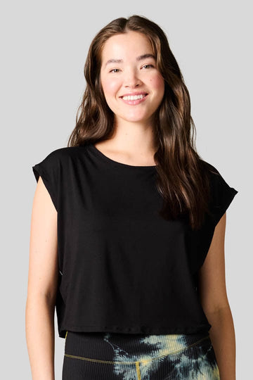Woman smiling wearing a black box tee. 