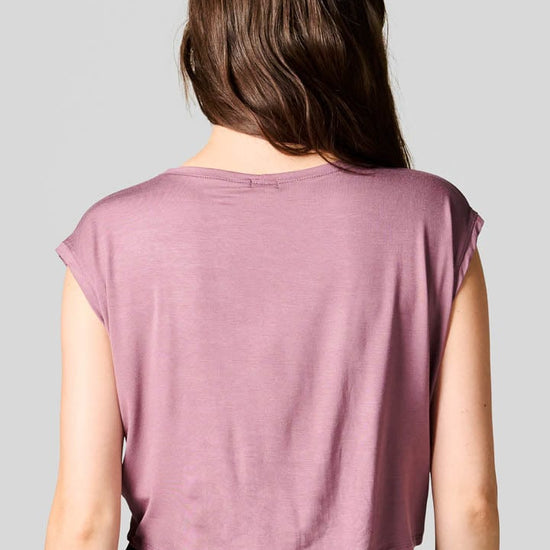 Back of a woman wearing a  pink tee