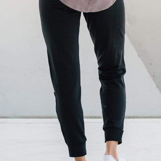 Woman wearing comfortable dressy lounge sweatpants in black made with sustainable fabrics for sustainable made-in-Canada joggers.