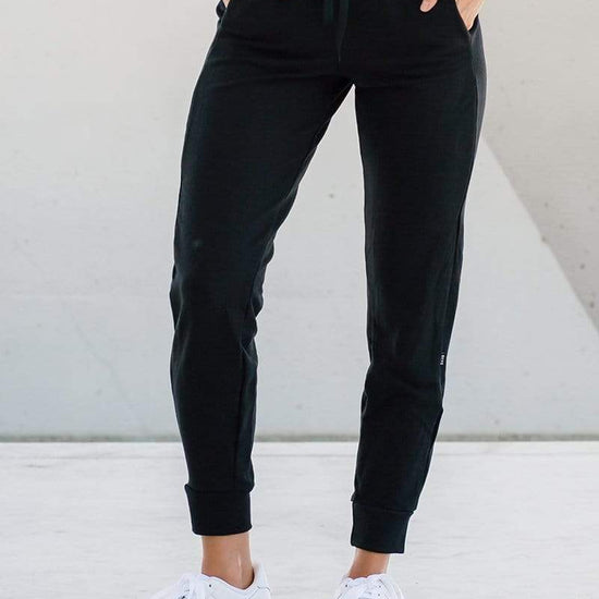 Woman wearing dressy joggers in black made ethically in Canada with sustainable fabrics, sustainable jogger sweatpants available online in Canada.
