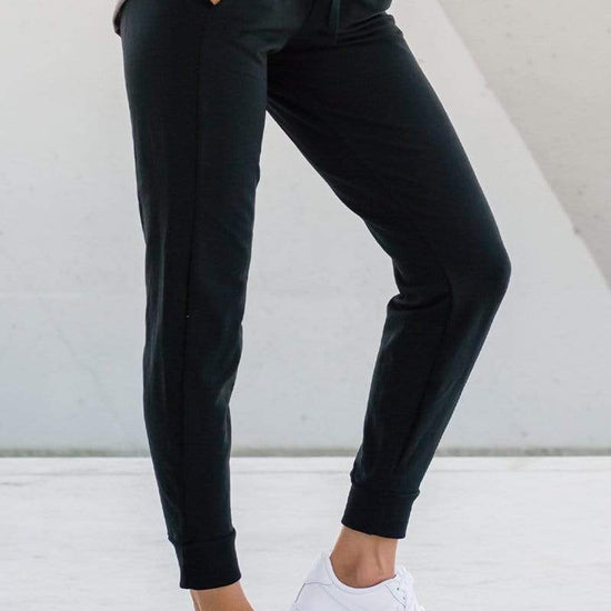 Side view woman wearing dressy jogger lounge pants in black made ethically in Canada with sustainable fabrics, sustainable jogger sweatpants available online in Canada.