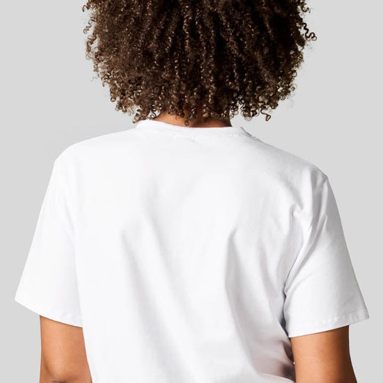 Back of a woman wearing a white tee.