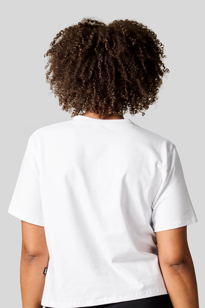 Back of a woman wearing a white tee.