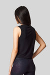 The back view of a sleeveless tank in black worn with black cheetah print leggings.