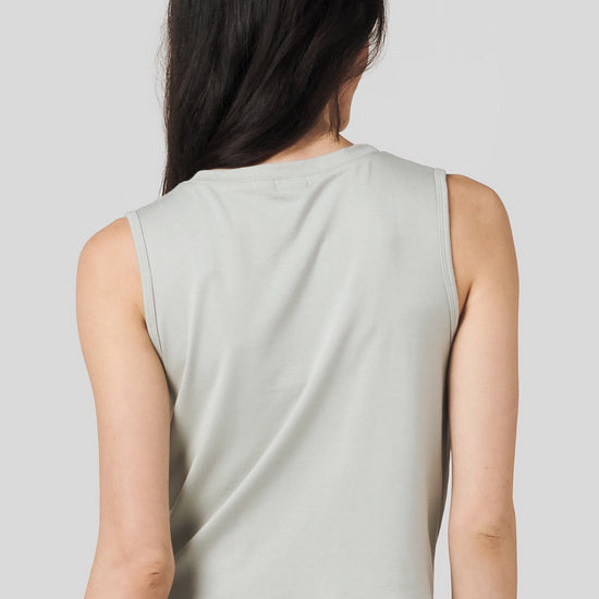 Back of a women wearing sage colour tank top and zebra print legging.